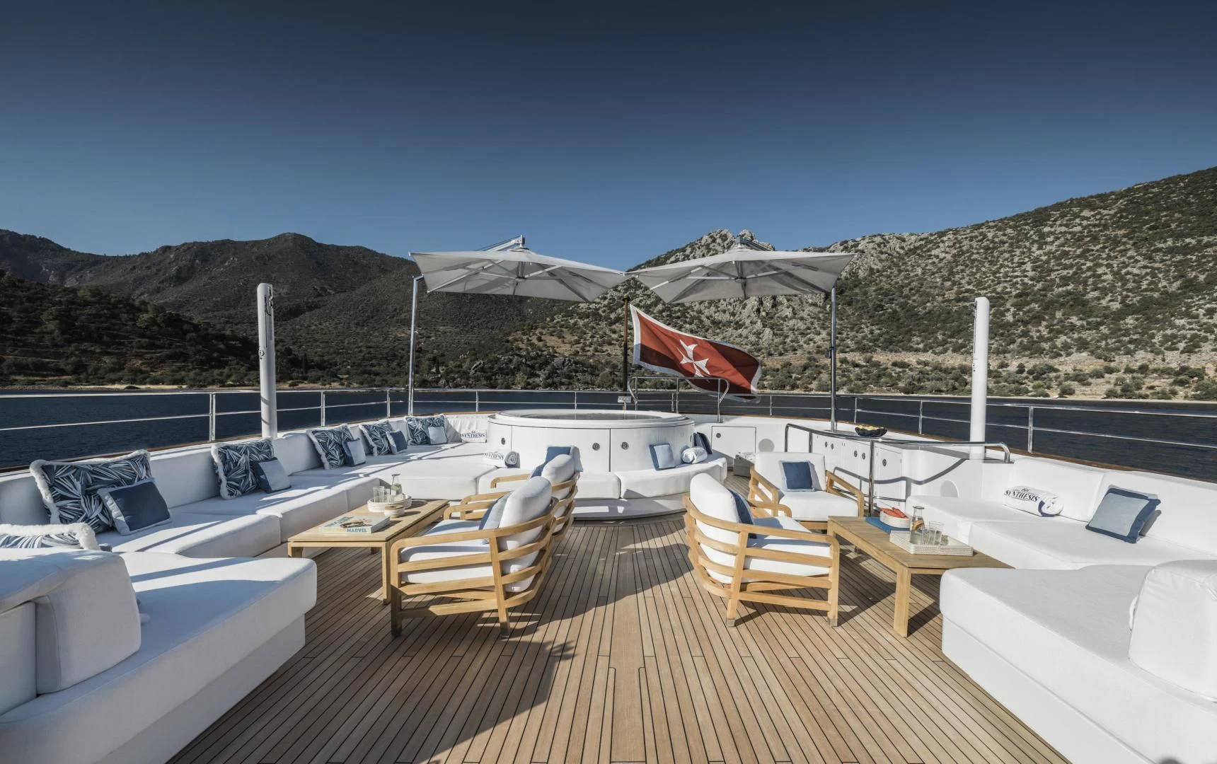 a deck with chairs and tables on it aboard SYNTHESIS 66 Yacht for Sale