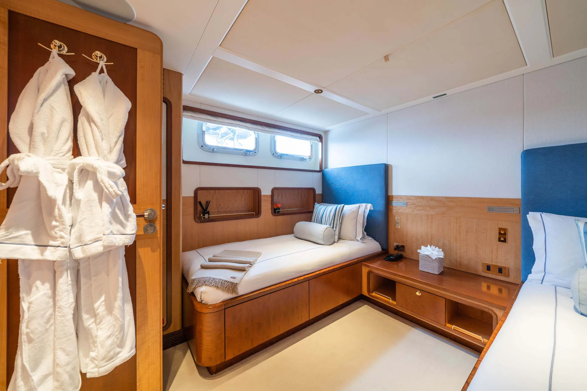 a bedroom with a bed and a dresser aboard SYNTHESIS 66 Yacht for Sale