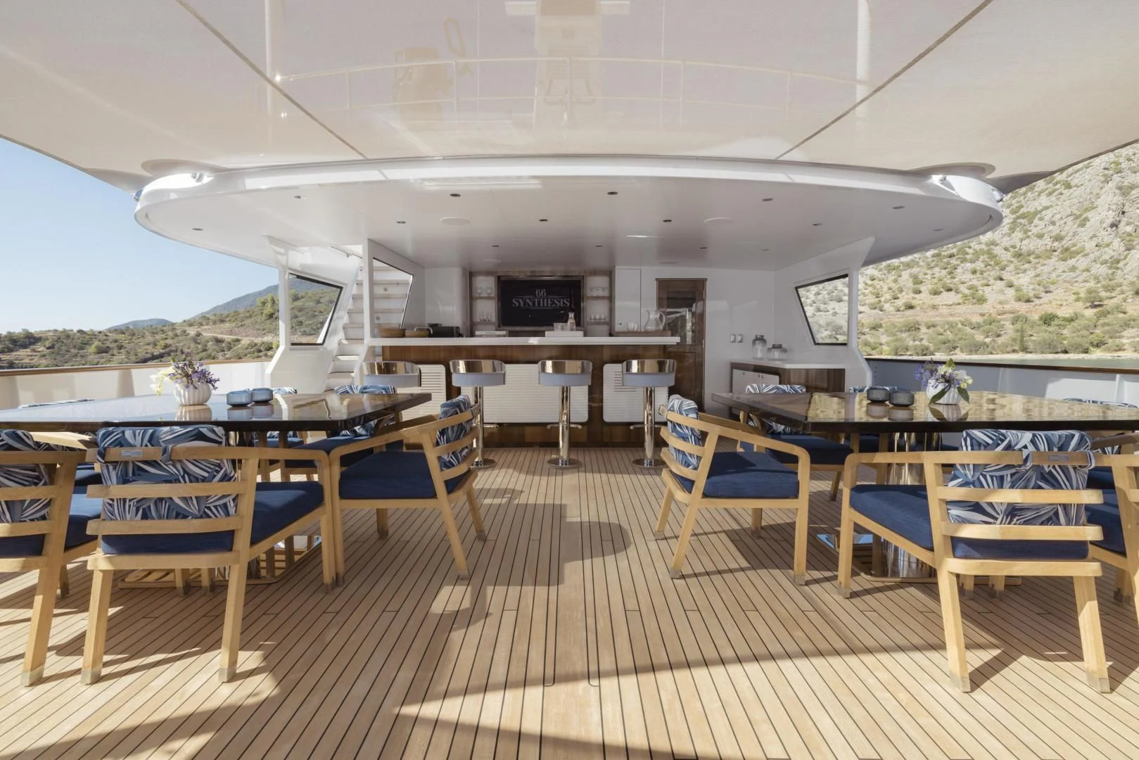 a deck with chairs and tables aboard SYNTHESIS 66 Yacht for Sale