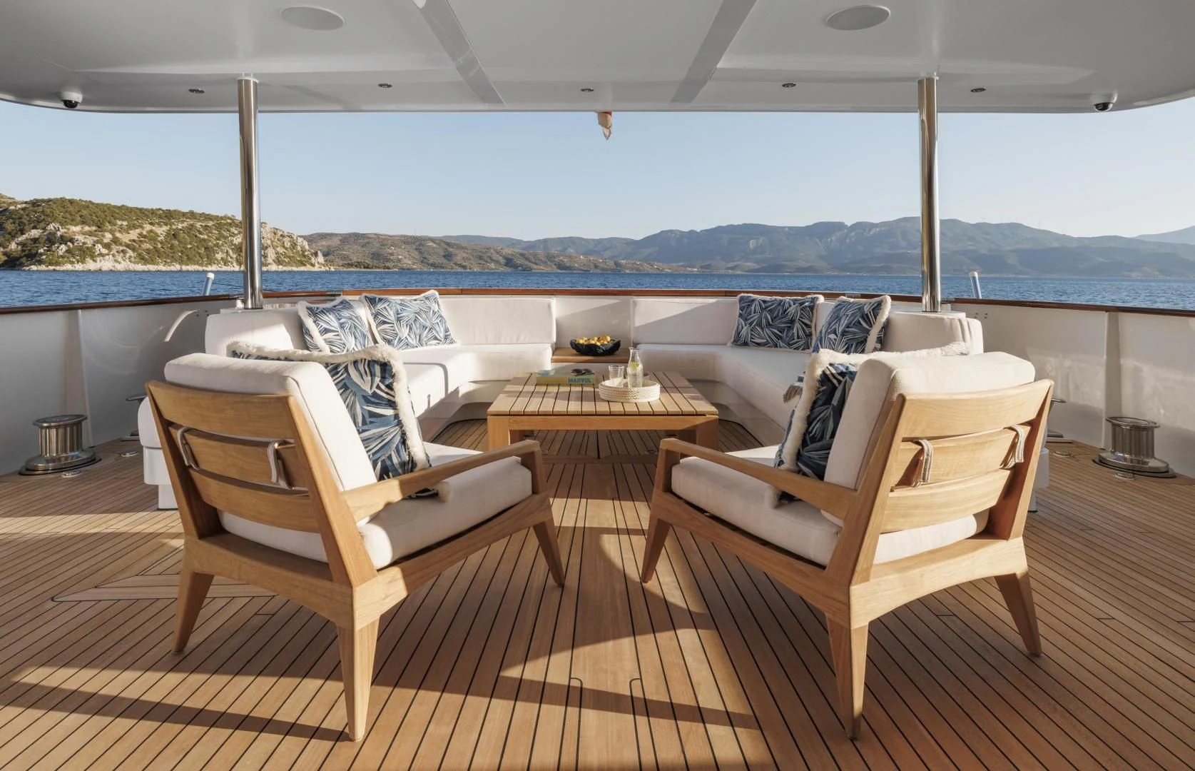 a deck with chairs and a table aboard SYNTHESIS 66 Yacht for Sale