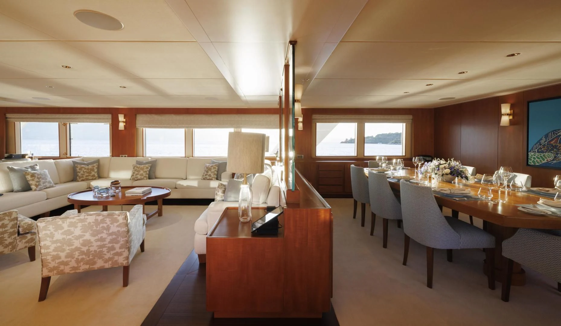 a large living room with a dining table and chairs aboard SYNTHESIS 66 Yacht for Sale
