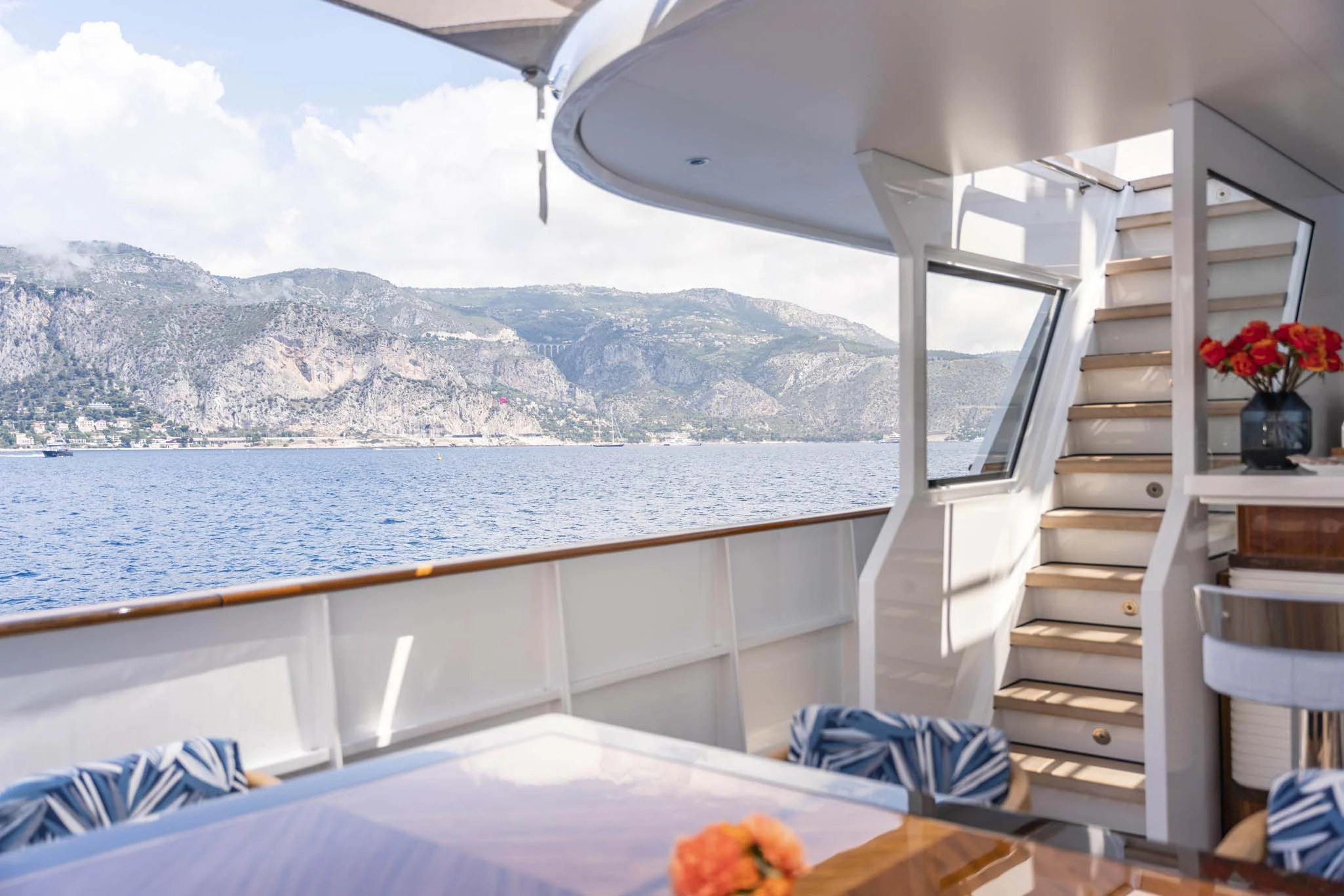 a room with a large window and a view of a mountain range aboard SYNTHESIS 66 Yacht for Sale