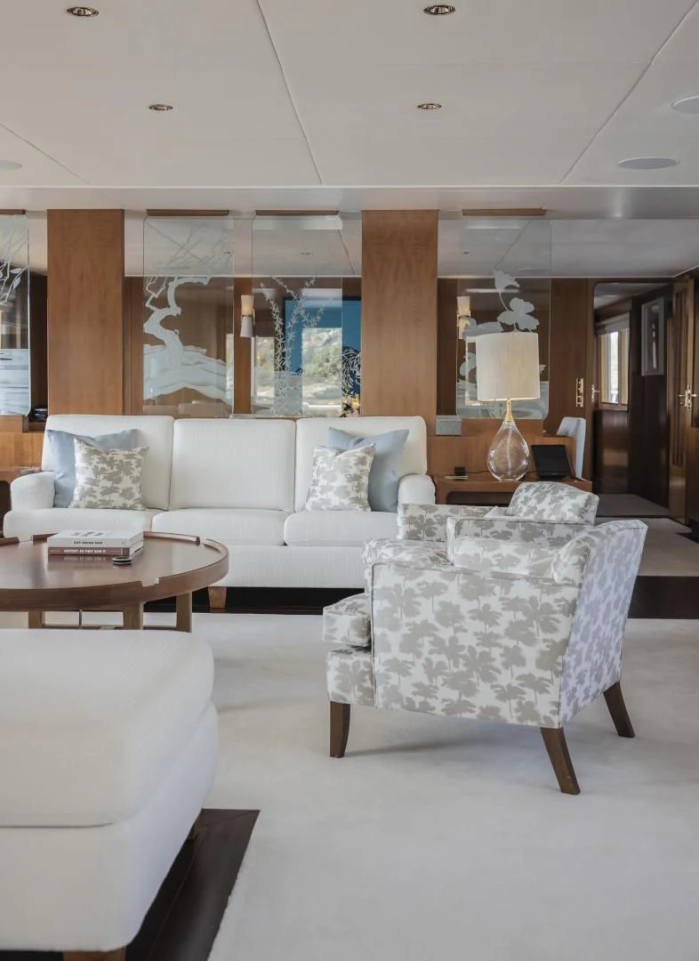 a living room with a large wood fireplace aboard SYNTHESIS 66 Yacht for Sale