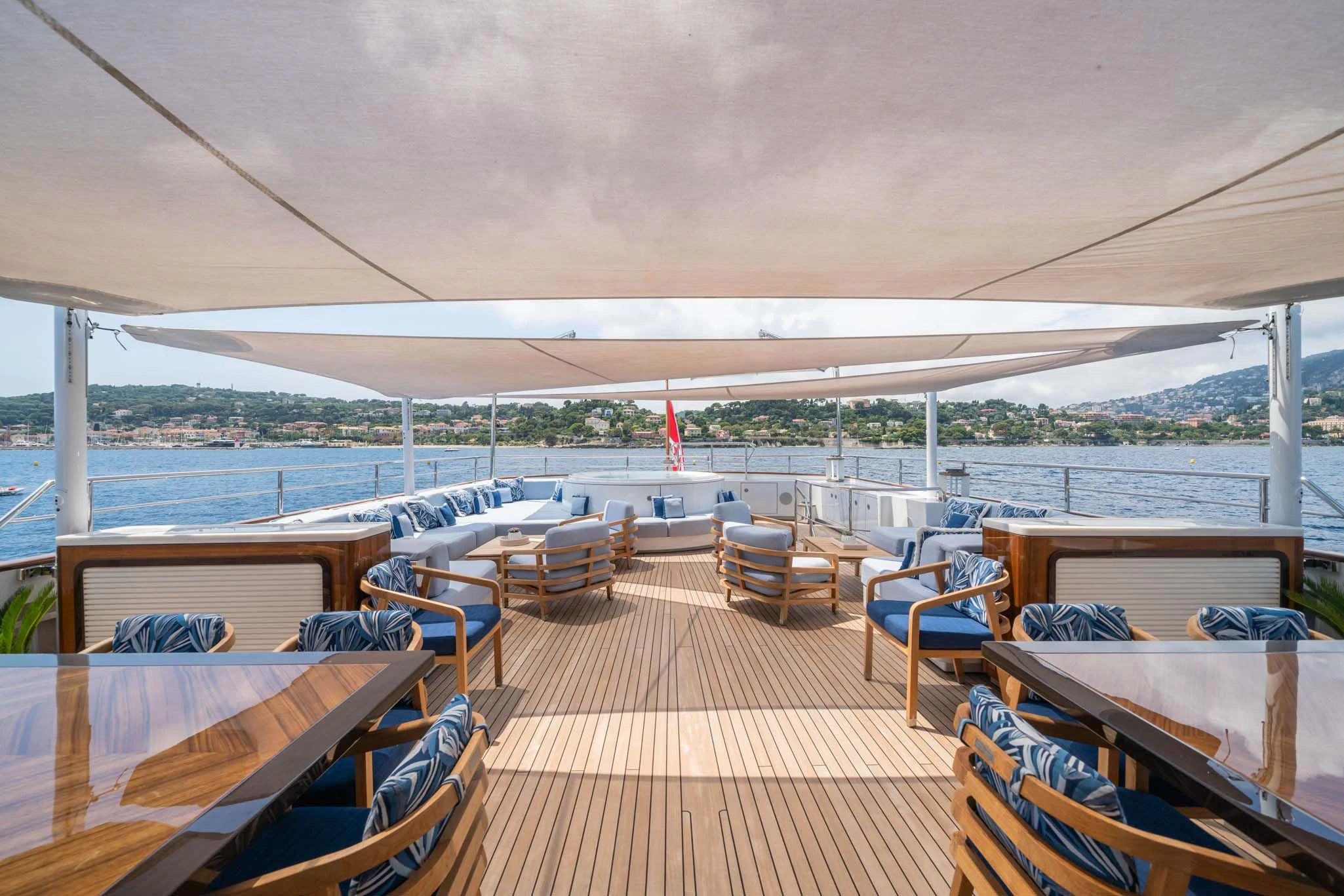 a deck with chairs and tables on it aboard SYNTHESIS 66 Yacht for Sale