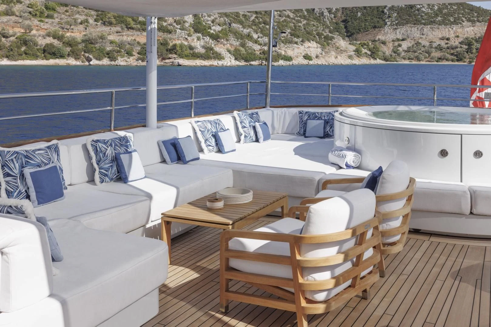 a deck with a table and chairs aboard SYNTHESIS 66 Yacht for Sale