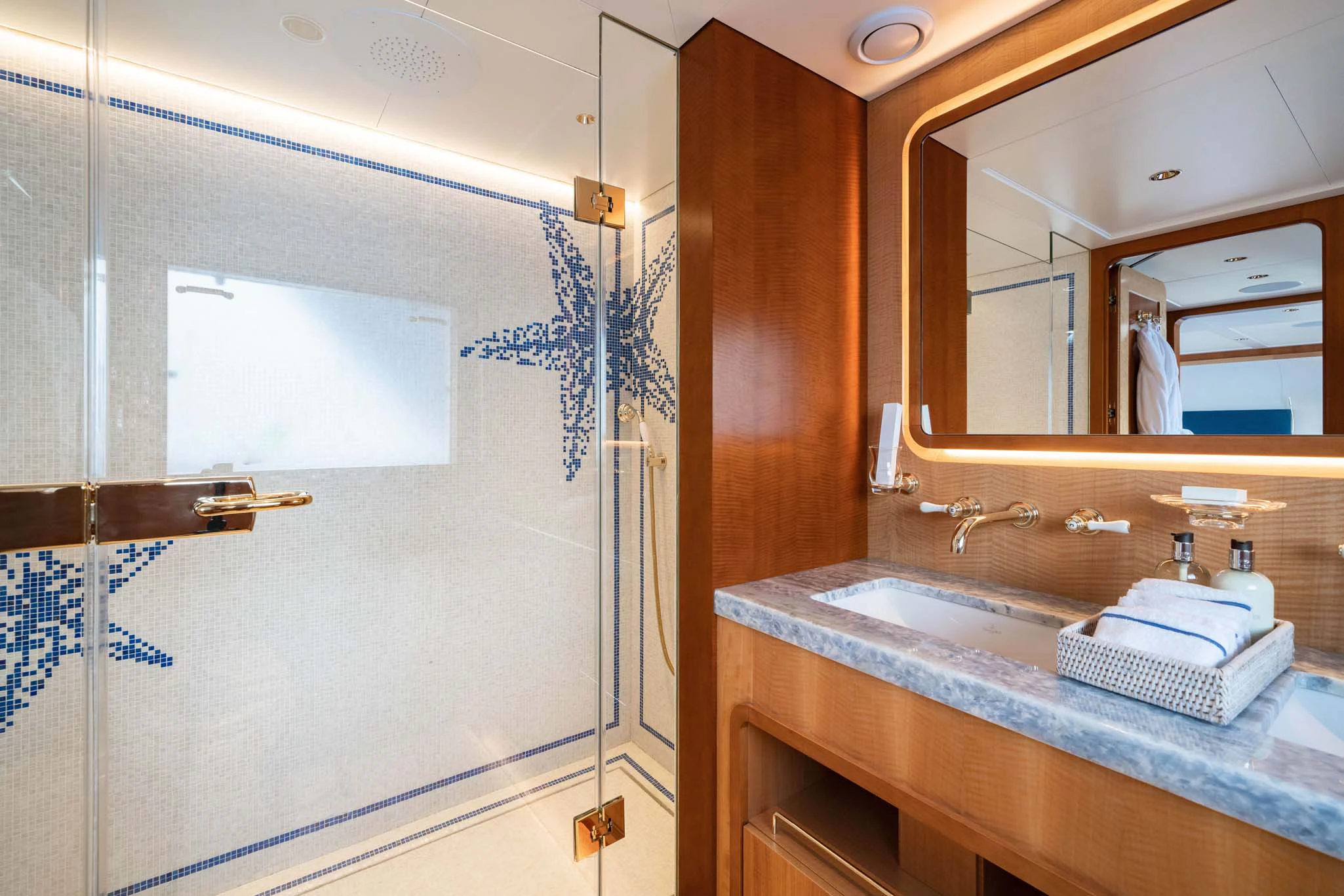 a bathroom with a sink and mirror aboard SYNTHESIS 66 Yacht for Sale