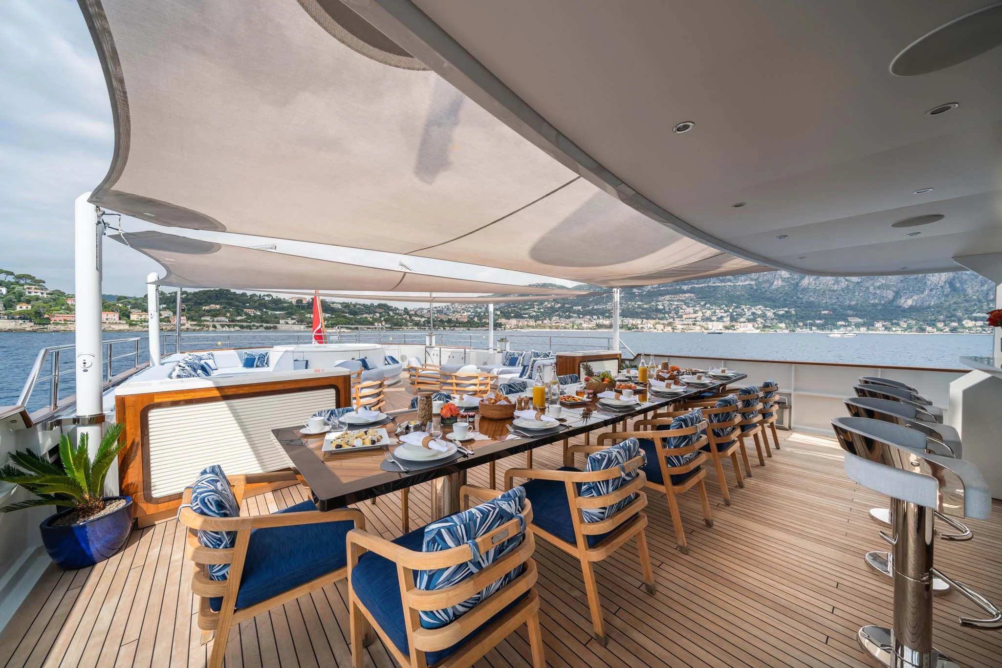 a deck with a table and chairs aboard SYNTHESIS 66 Yacht for Sale