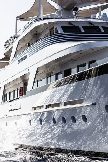 a white boat with black text aboard SYNTHESIS 66 Yacht for Sale