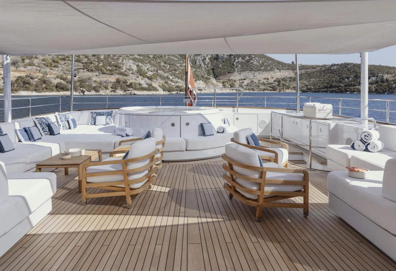 a deck with chairs and tables on it aboard SYNTHESIS 66 Yacht for Sale