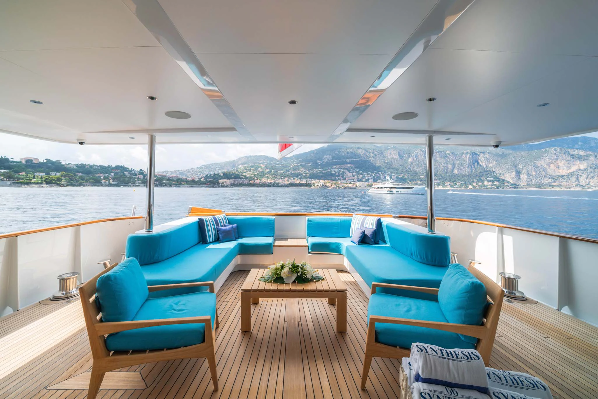 a deck with chairs and a table aboard SYNTHESIS 66 Yacht for Sale