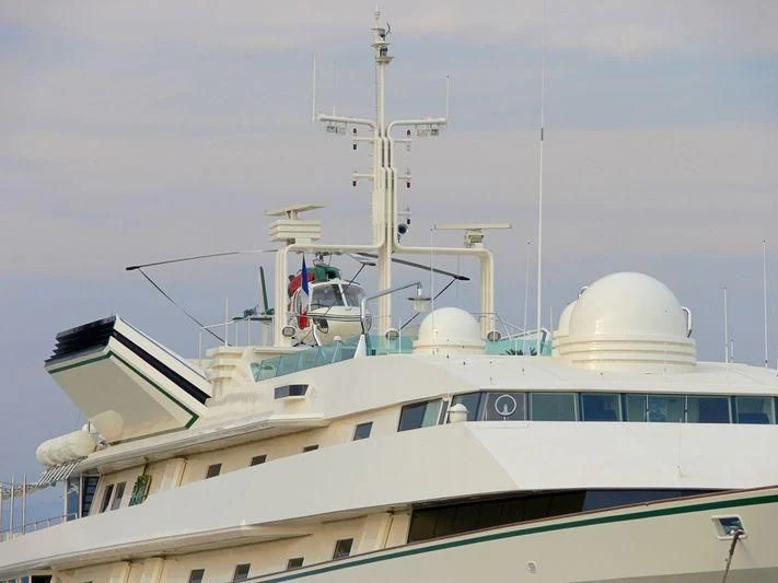 a large white ship with a satellite on top aboard KINGDOM 5KR Yacht for Sale
