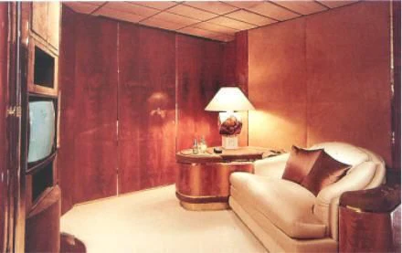 a room with a couch and a table aboard KINGDOM 5KR Yacht for Sale