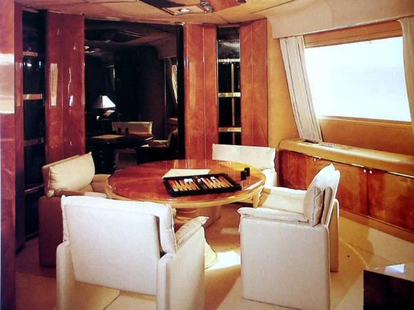 a living room with a table and chairs aboard KINGDOM 5KR Yacht for Sale