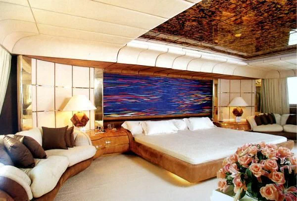 a room with a bed and a couch aboard KINGDOM 5KR Yacht for Sale