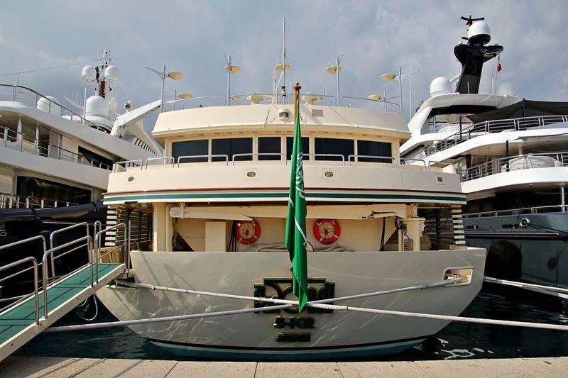 a large white boat in a harbor aboard KINGDOM 5KR Yacht for Sale