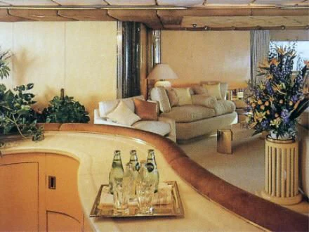 a large room with a table and couches aboard KINGDOM 5KR Yacht for Sale