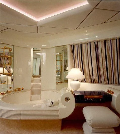 a bathroom with a bathtub and a bed aboard KINGDOM 5KR Yacht for Sale