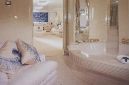 a bathroom with a bathtub and a bed aboard KINGDOM 5KR Yacht for Sale