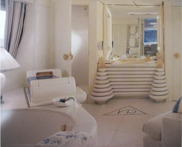 a room with a bed and a dresser aboard KINGDOM 5KR Yacht for Sale