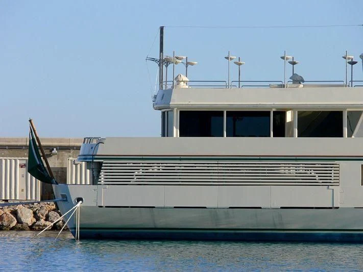 a white boat with a wind turbine on top aboard KINGDOM 5KR Yacht for Sale