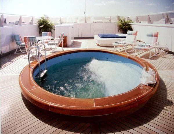 a pool with a table and chairs aboard KINGDOM 5KR Yacht for Sale