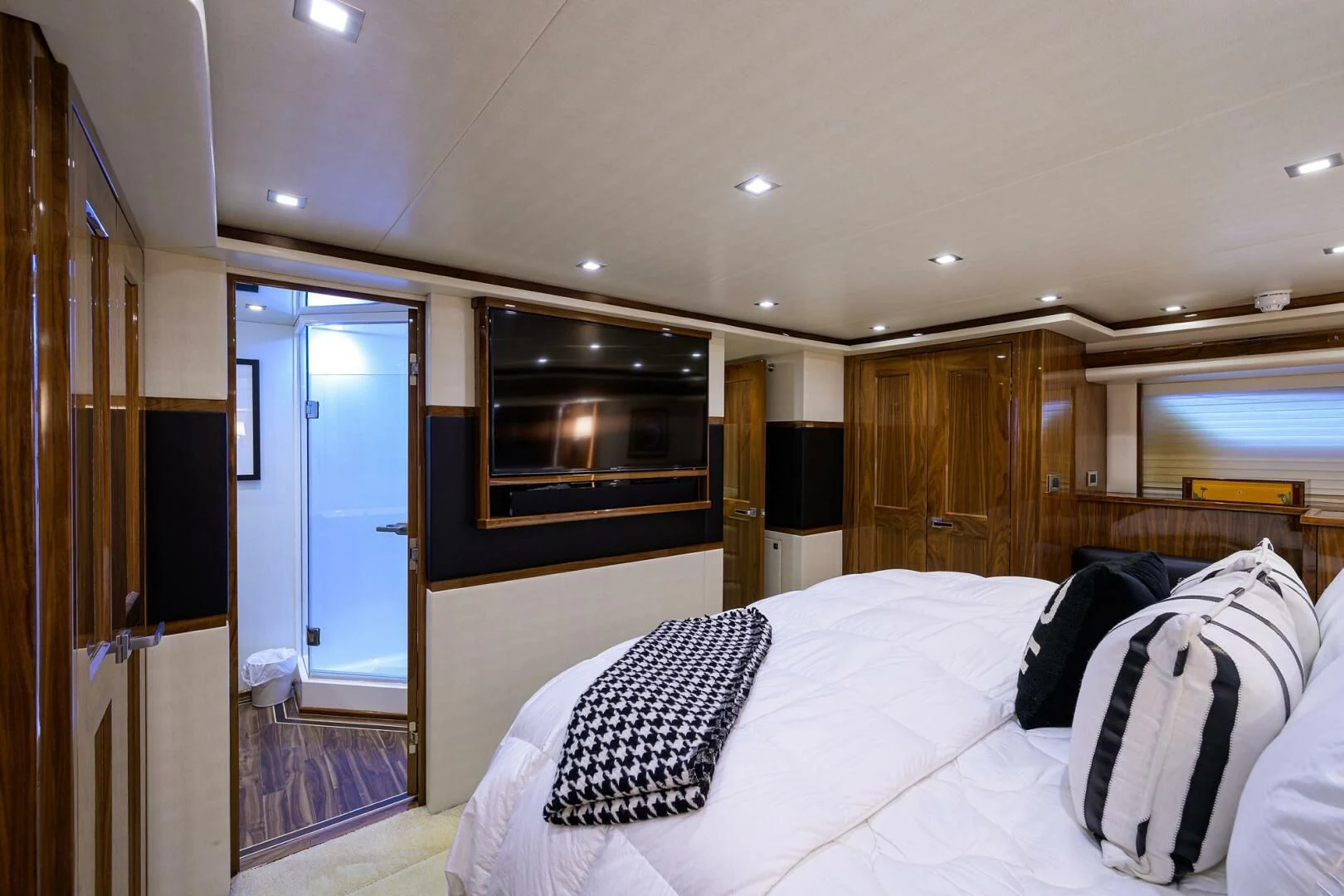 a bedroom with a large bed aboard 80' VIKING Yacht for Sale