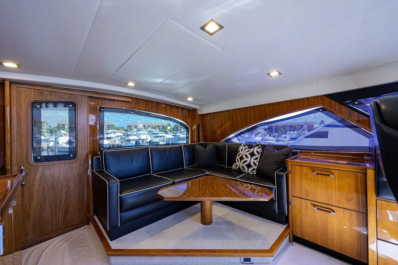 a living room with a leather couch aboard 80' VIKING Yacht for Sale