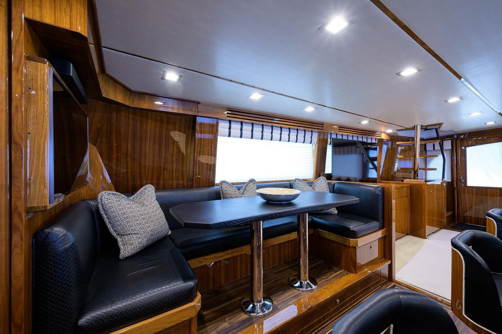 a room with a couch and a table and chairs aboard 80' VIKING Yacht for Sale