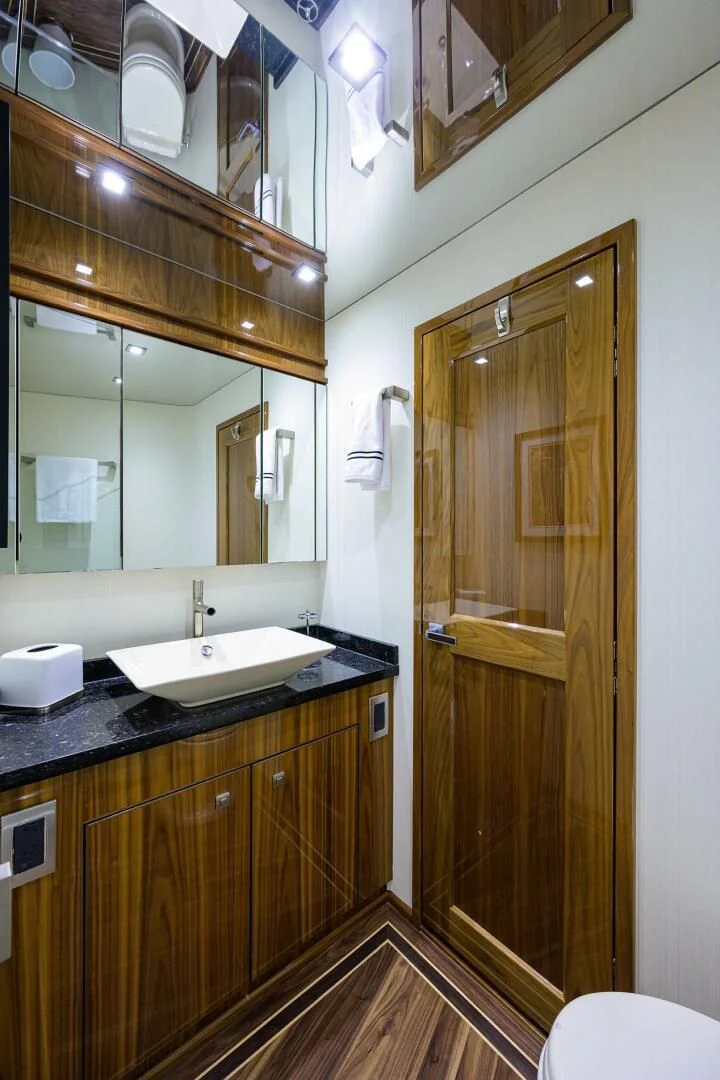 a bathroom with a glass shower door aboard 80' VIKING Yacht for Sale