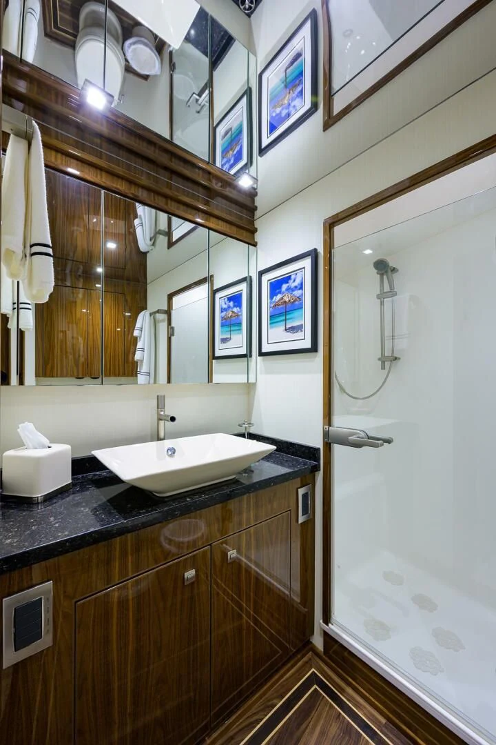 a bathroom with a sink and a mirror aboard 80' VIKING Yacht for Sale