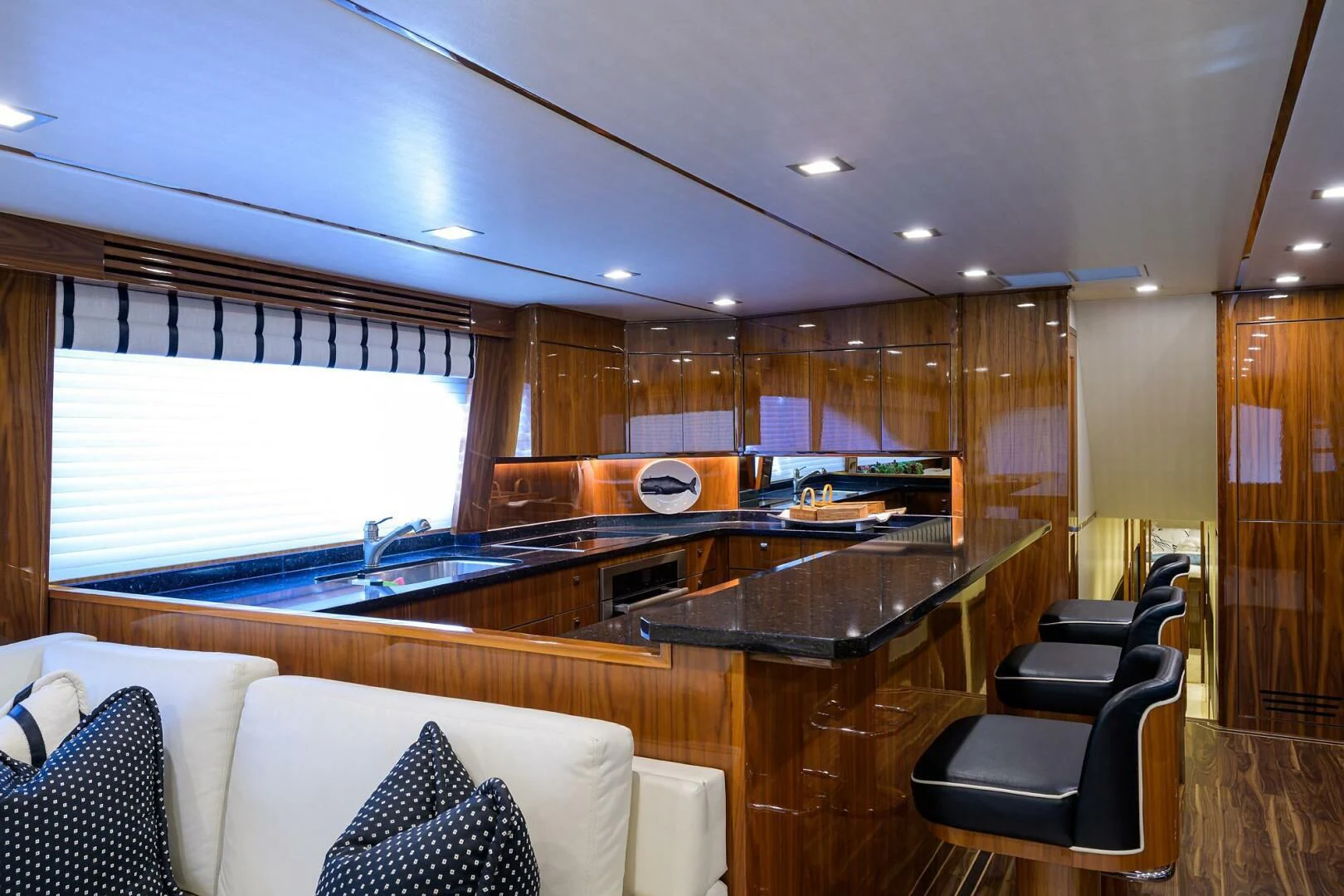 a large kitchen with a bar aboard 80' VIKING Yacht for Sale