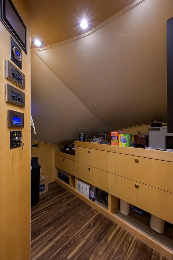 a room with a wood cabinet and shelves with objects on it aboard 80' VIKING Yacht for Sale
