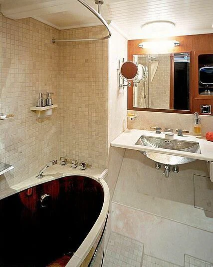 a bathroom with a tub sink and a sink aboard DOLPHIN Yacht for Sale