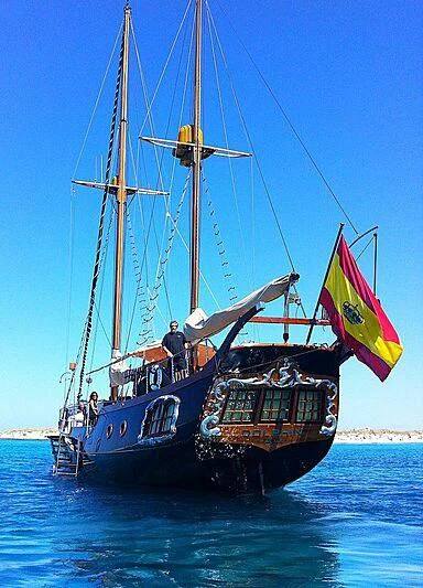 a boat with a flag on it aboard DOLPHIN Yacht for Sale