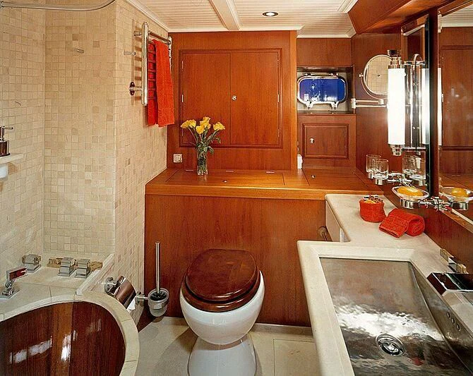 a bathroom with a toilet sink and a bathtub aboard DOLPHIN Yacht for Sale