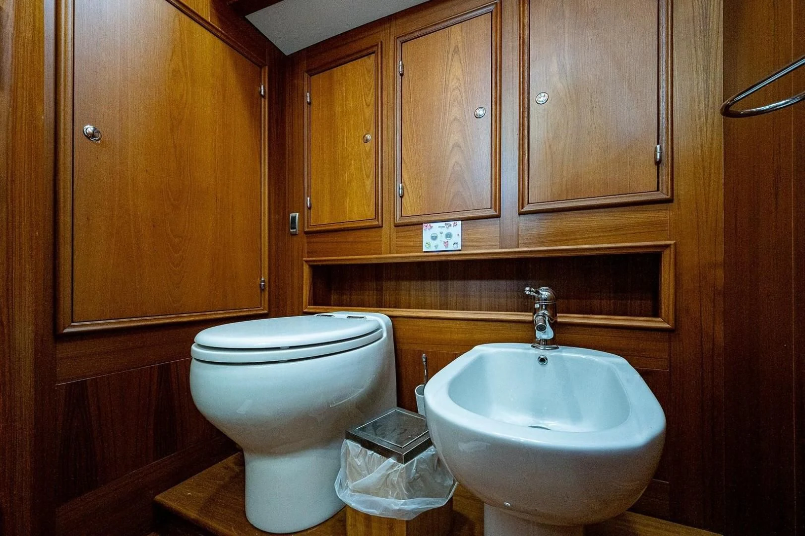 a bathroom with wooden cabinets aboard ATALI Yacht for Sale