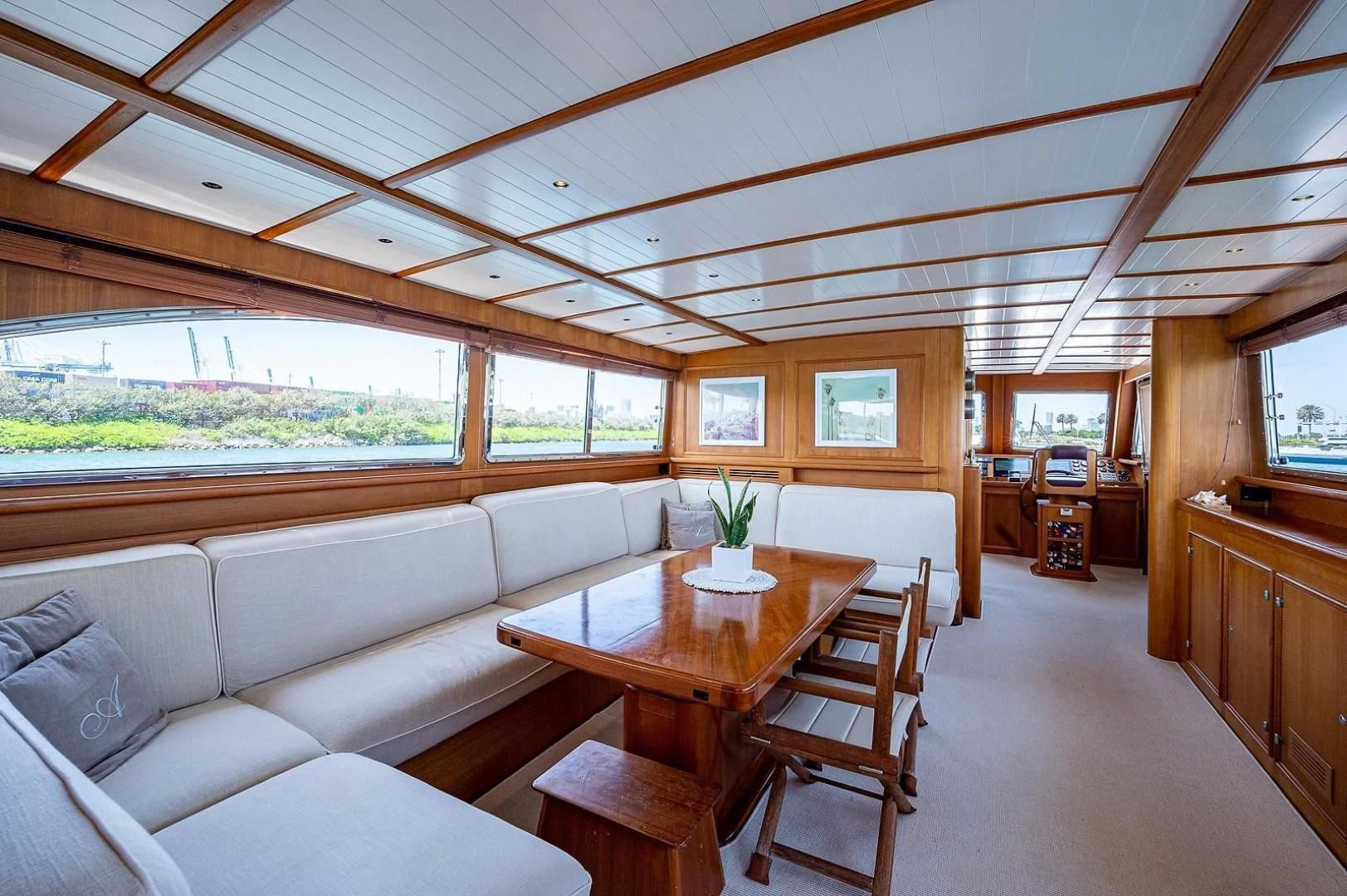 a living room with a table and chairs aboard ATALI Yacht for Sale