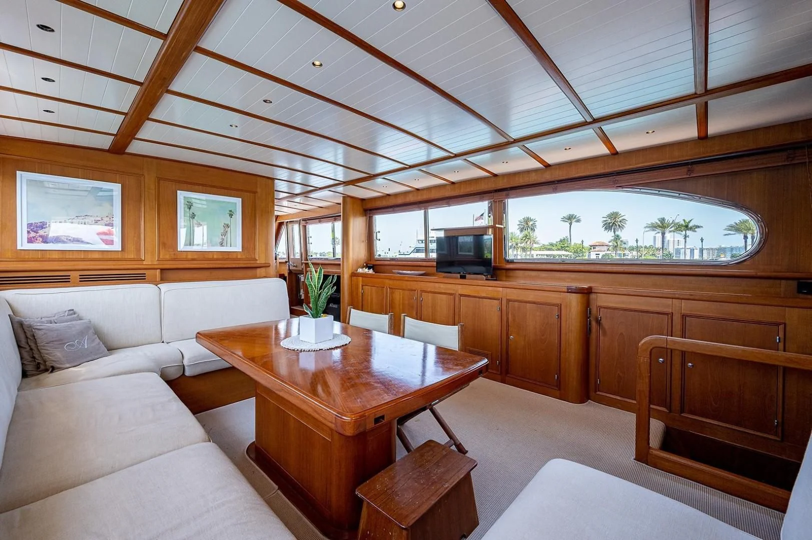 a room with a table and couch aboard ATALI Yacht for Sale