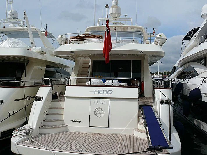a boat with a flag on the front aboard HERO Yacht for Sale