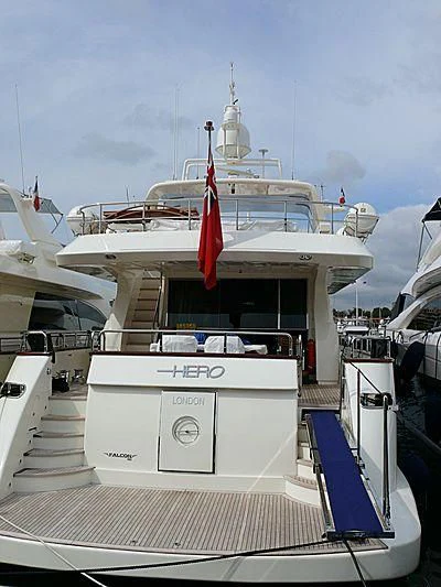 a boat with a flag on the front aboard HERO Yacht for Sale