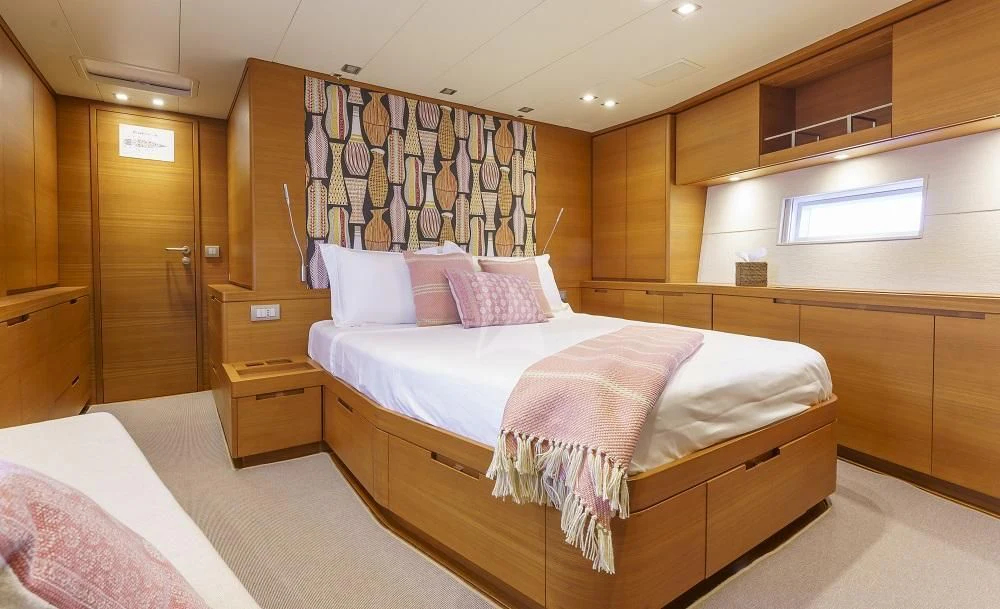 a room with a bed and a desk aboard FREEBIRD Yacht for Sale
