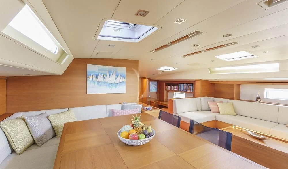 a room with a couch and a table with a bowl of fruit aboard FREEBIRD Yacht for Sale