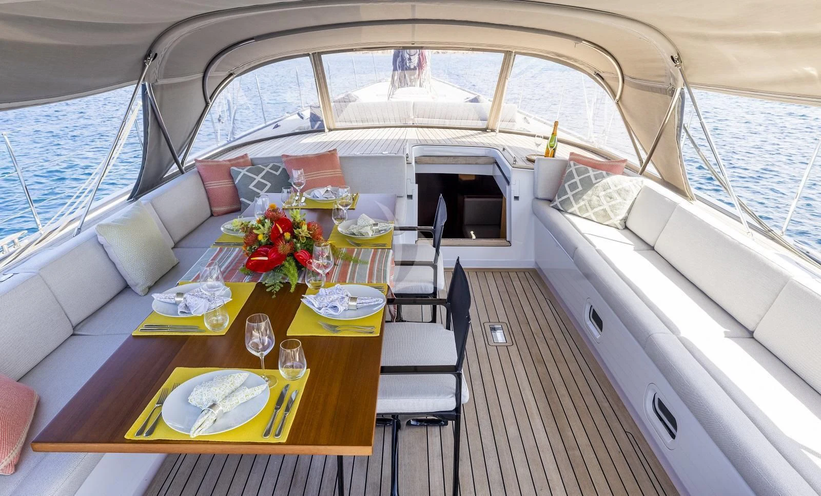 a boat with a table and chairs aboard FREEBIRD Yacht for Sale