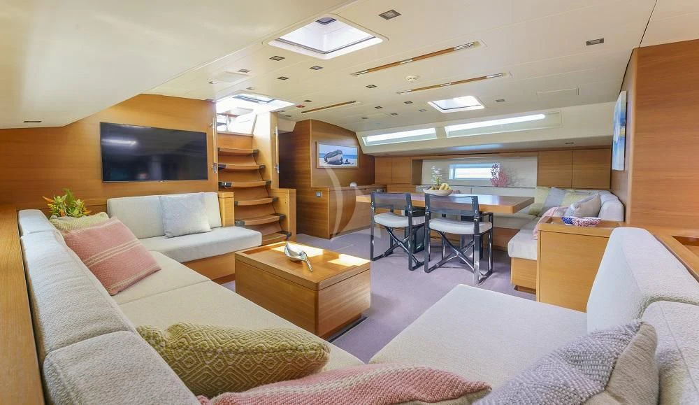 a living room with a couch and a table aboard FREEBIRD Yacht for Sale