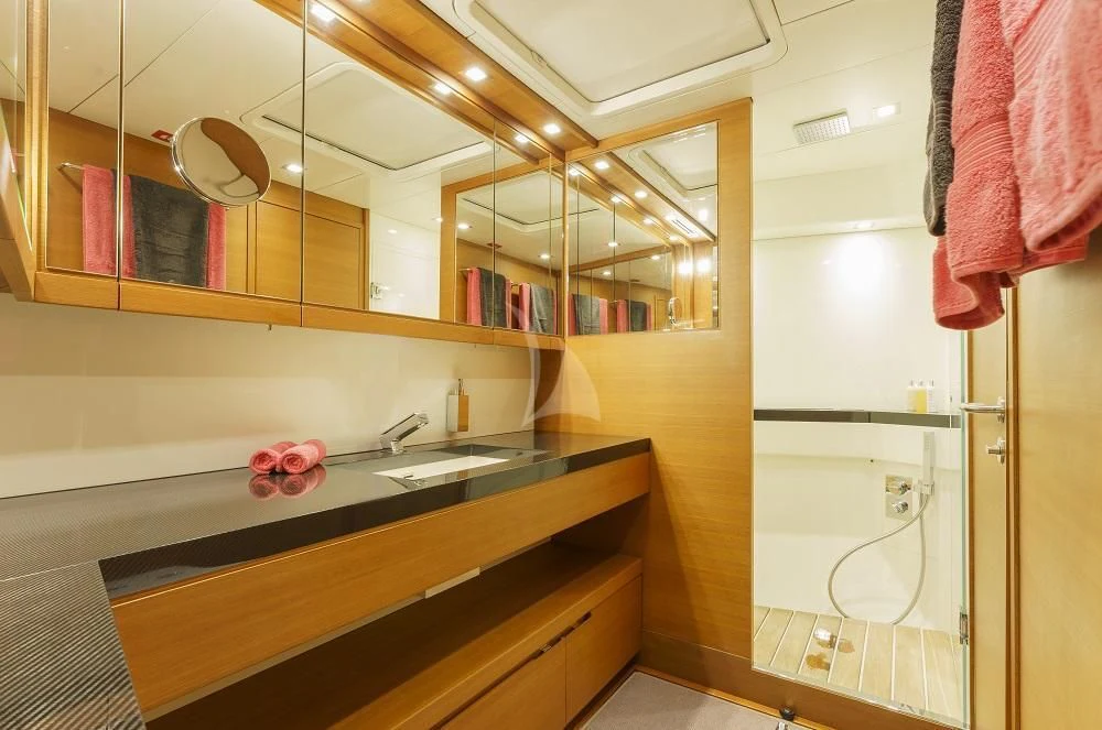 a bathroom with a large mirror aboard FREEBIRD Yacht for Sale