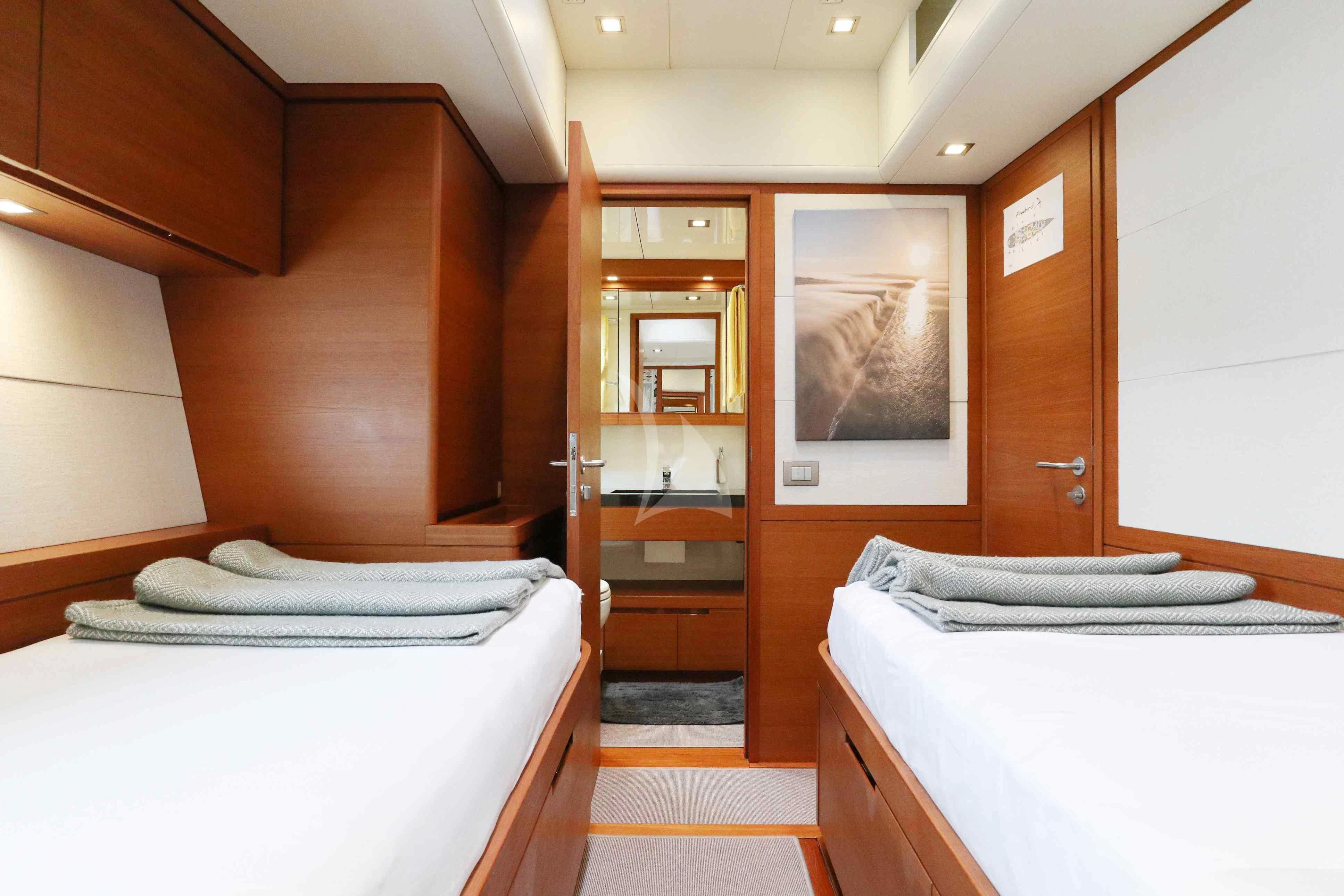 a room with a bed and a mirror aboard FREEBIRD Yacht for Sale
