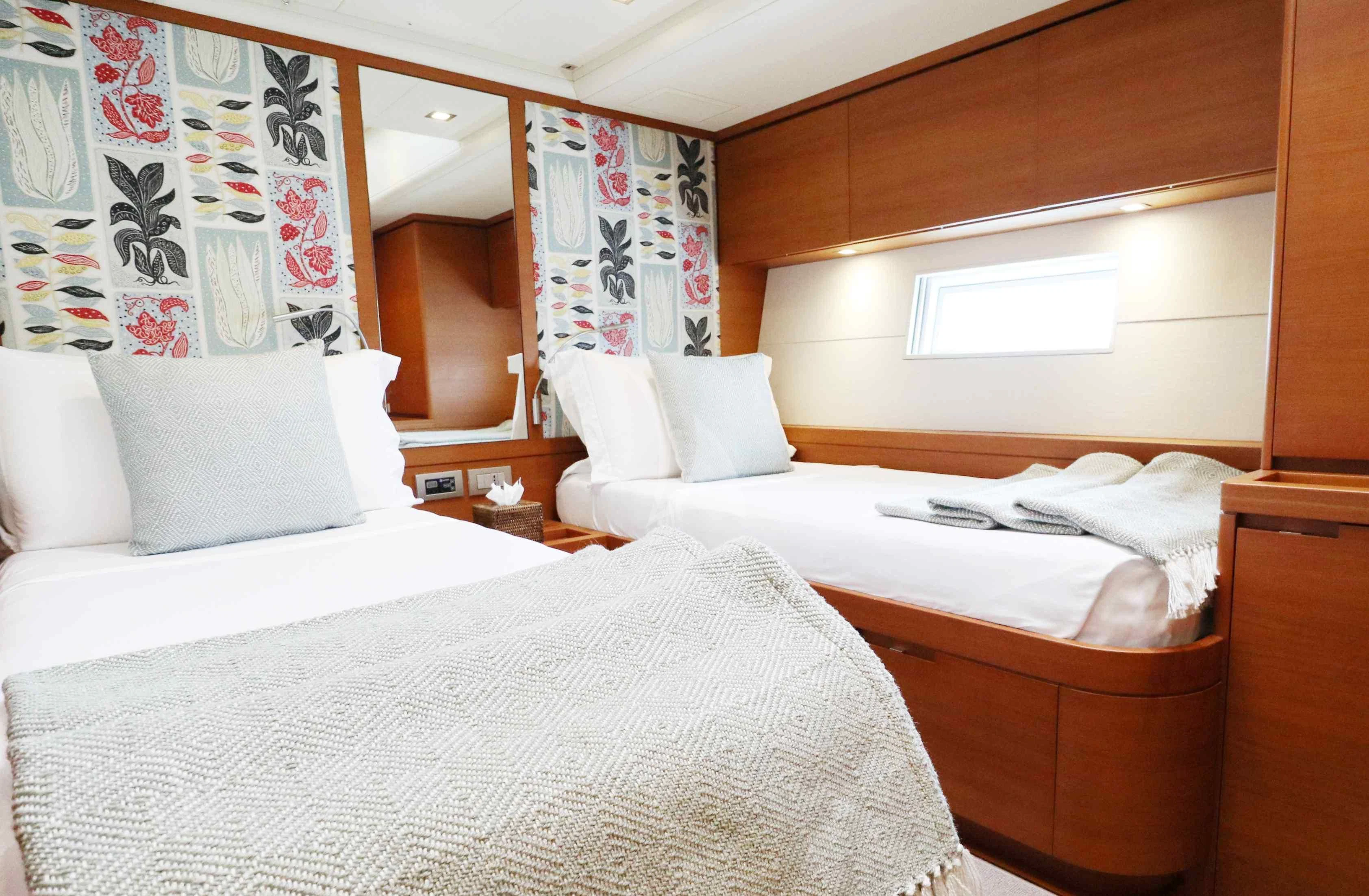 a room with two beds aboard FREEBIRD Yacht for Sale