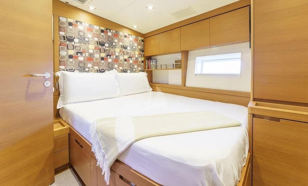 a room with a bed and cabinets aboard FREEBIRD Yacht for Sale