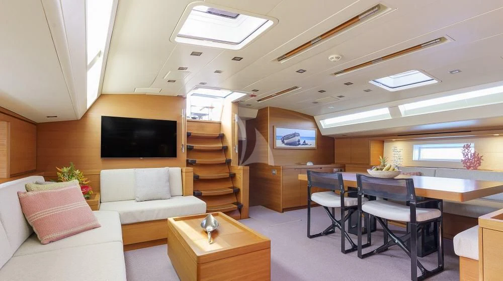 a room with a couch and a tv aboard FREEBIRD Yacht for Sale