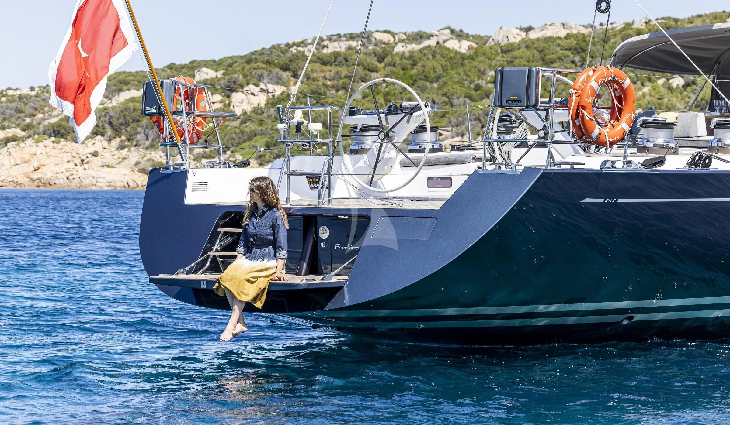 a person jumping off a boat aboard FREEBIRD Yacht for Sale